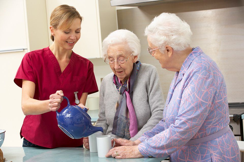 woman helping out 2 senior women with their coffee
