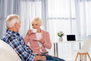 senior couple enjoying cup of coffee in home