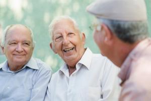 three senior men talking and laughing