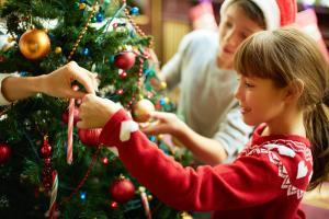 Happy children decorating a Christmas tree