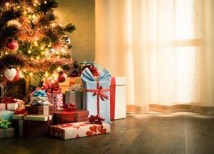 Presents beneath Christmas tree, near window