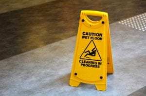 slippery floor surface warning sign and symbol, reading "caution wet floor – cleaning in progress"
