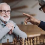 Smiling senior men playing chess