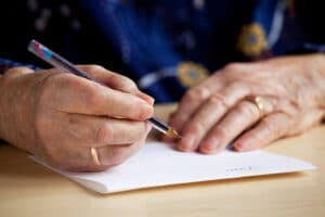 Close-up of senior woman writing letter