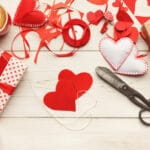 Paper hearts, scissors, ribbon, latte with heart in foam, etc