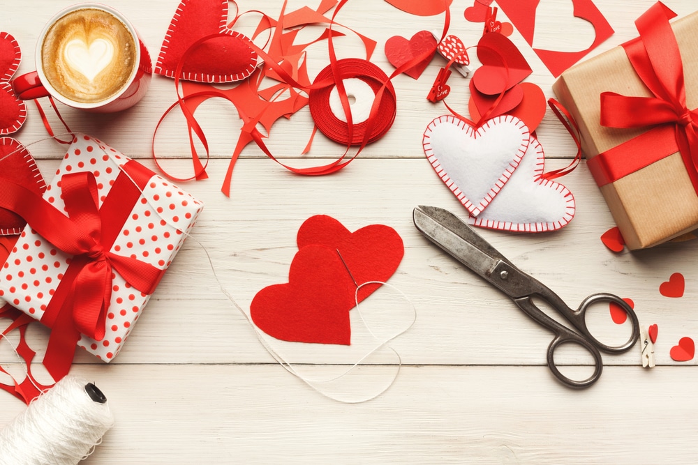 Paper hearts, scissors, ribbon, latte with heart in foam, etc