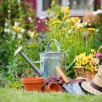 Flower pot, shovel, hat, basket, gloves in garden