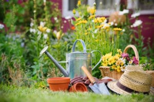 Flower pot, shovel, hat, basket, gloves in garden