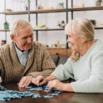Happy senior couple doing a puzzle