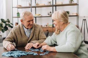 Happy senior couple doing a puzzle