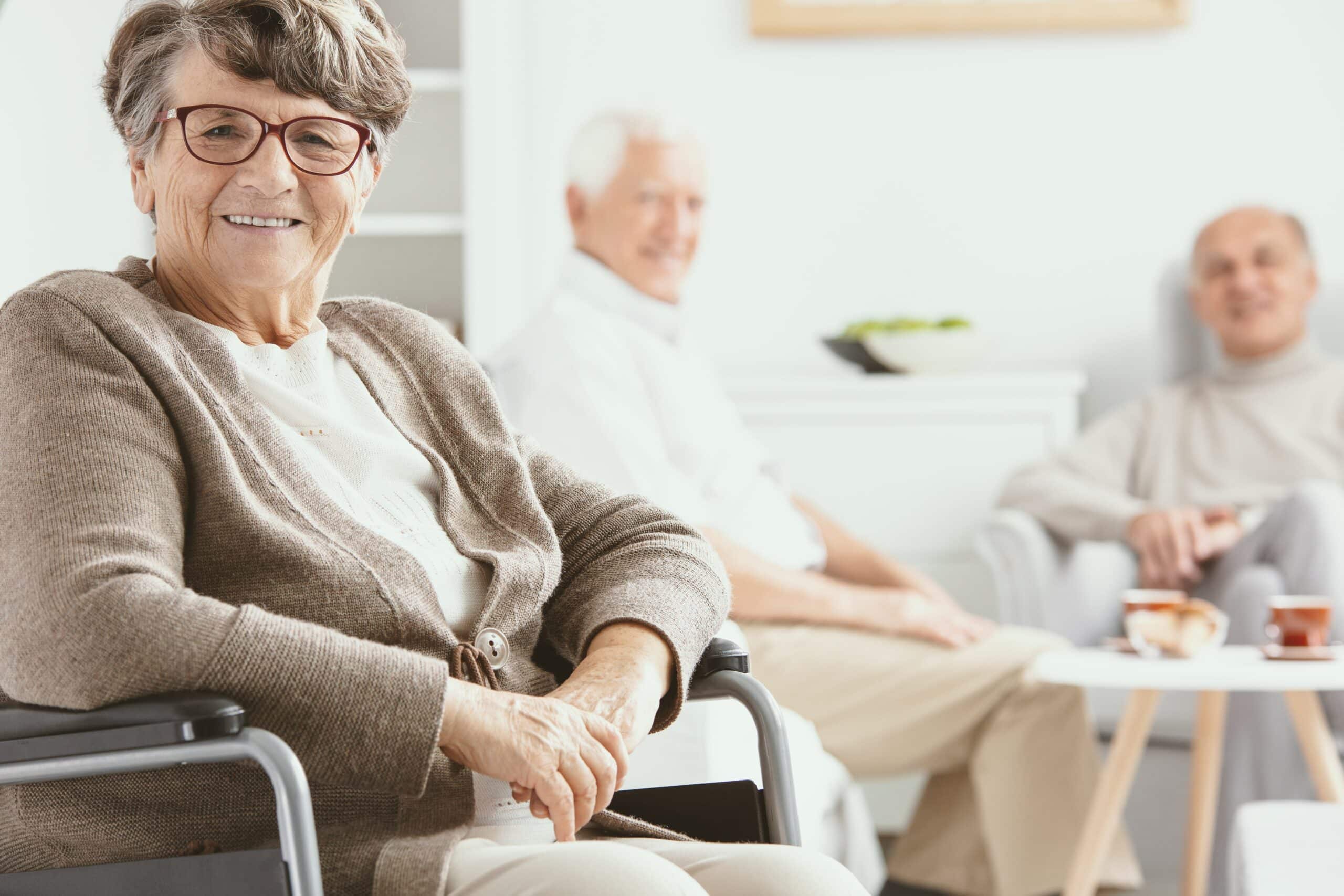 Senior woman in wheelchair in senior living community, smiling