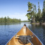 Tip of canoe in Minnesota lake in summer